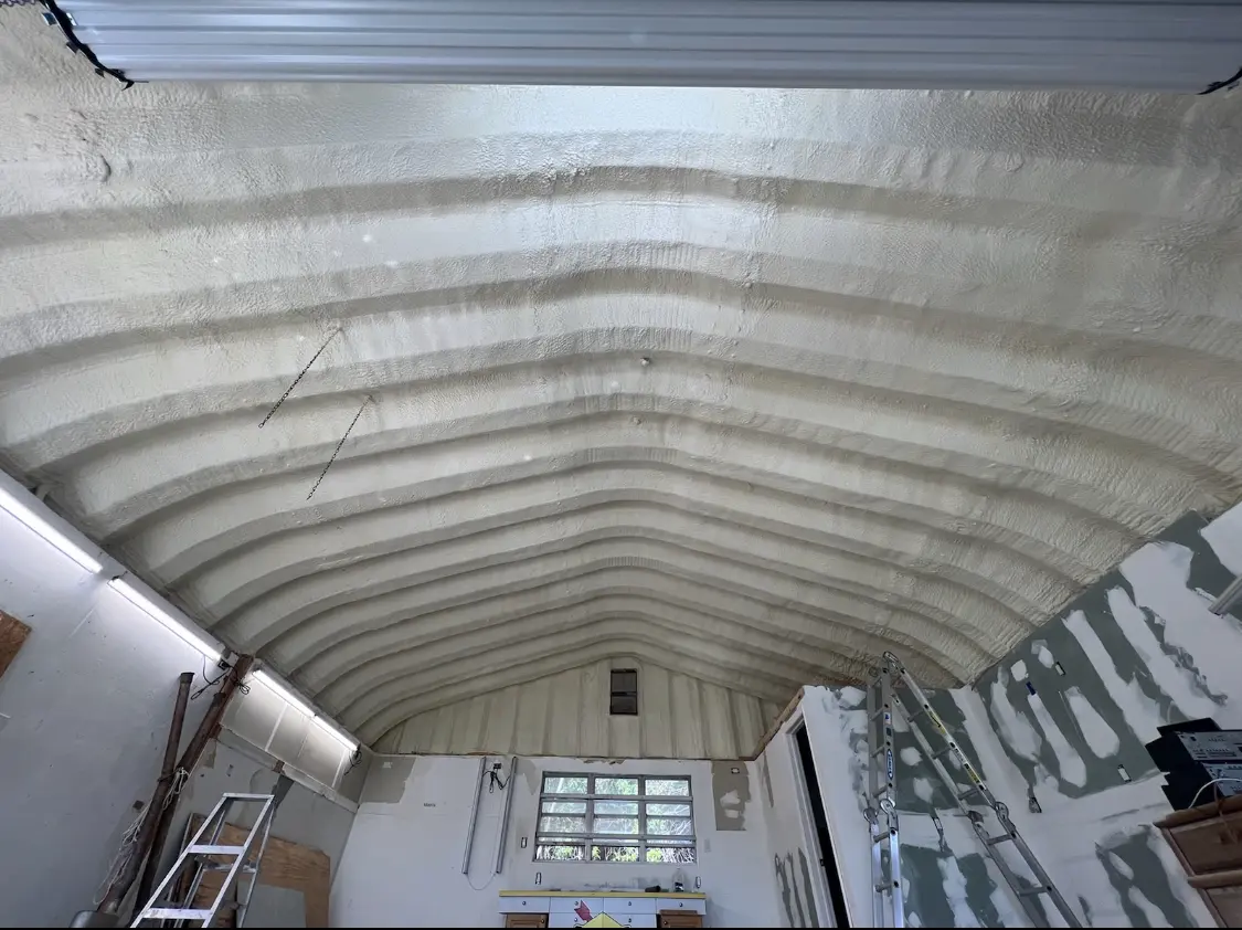 Spray polyurethane foam applied to the underside of a metal roof deck in Vinings